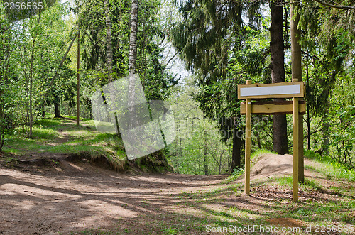 Image of Wooden sign board on the natural trail. In the 
 forest park