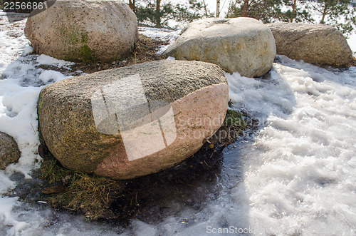 Image of four large stones in the snow 