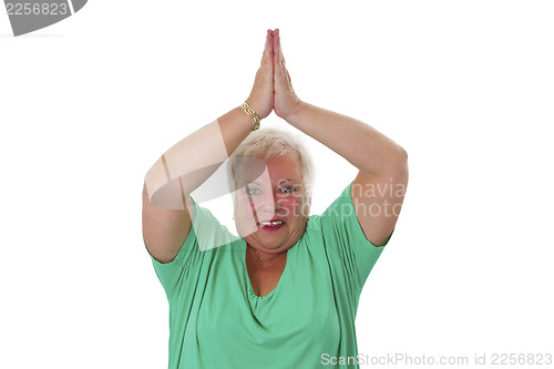 Image of Female senior in yoga meditating 