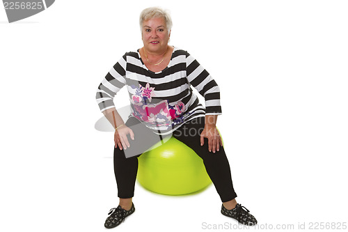 Image of Female senior sitting on swiss ball