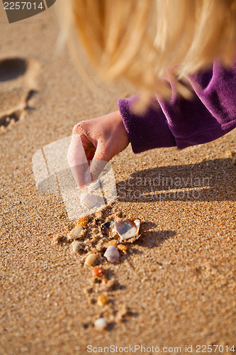 Image of Young girl playing with shells