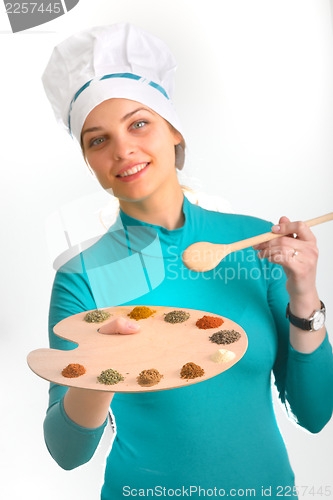 Image of Spices and herbs on the palette and cook girl 