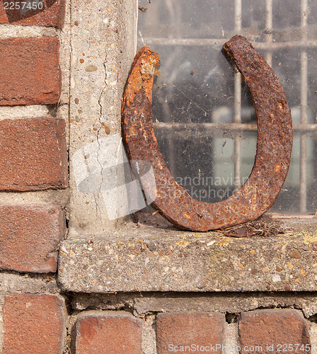 Image of Single horseshoe in front of a window