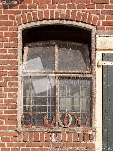 Image of Horseshoes in front of a window