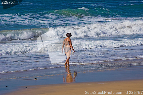 Image of Beach female walking on a sunny day