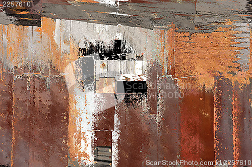 Image of Peeling paint on rusted metal surface