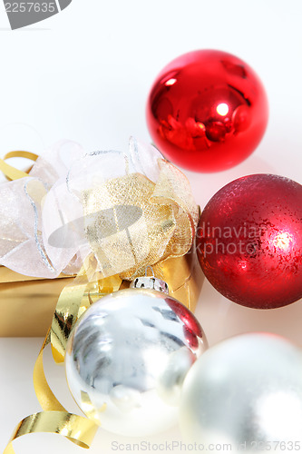 Image of Gold wrapped gift with Christmas baubles