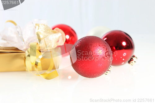 Image of Red Christmas balls and a luxury gift