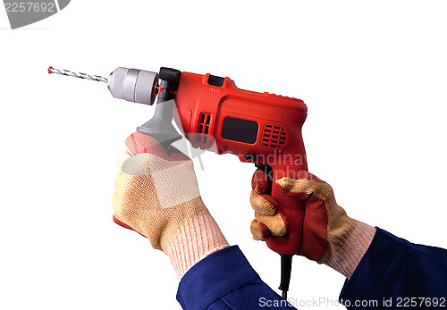 Image of Gloved hands with electric drill