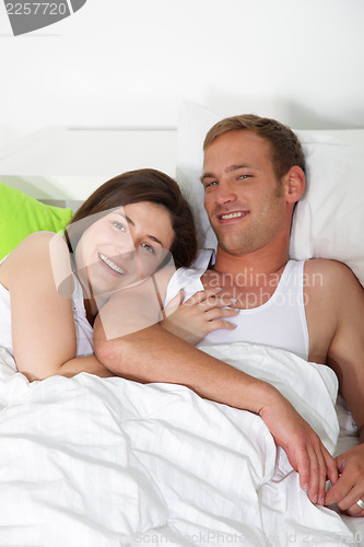 Image of Happy young couple in bed