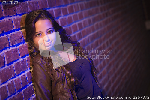 Image of Pretty Mixed Race Young Adult Woman Against a Brick Wall