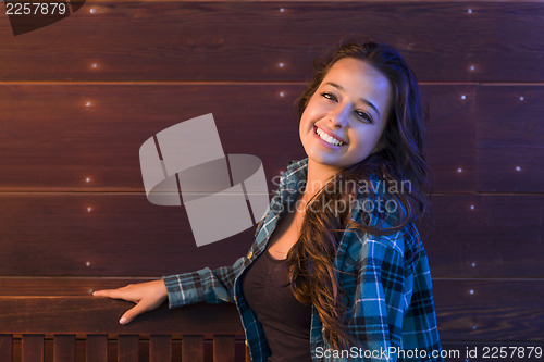 Image of Mixed Race Young Adult Woman Portrait Sitting on Wood Bench