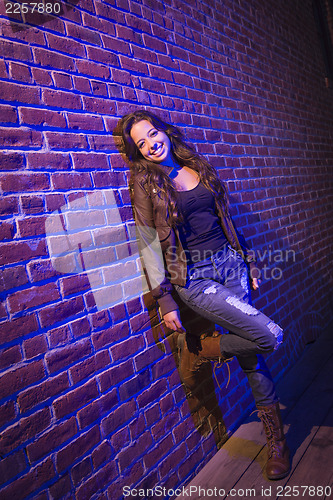 Image of Pretty Mixed Race Young Adult Woman Against a Brick Wall