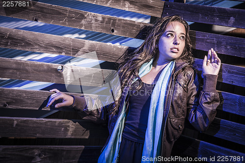 Image of Frightened Pretty Young Woman in Dark Walkway at Night