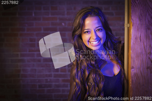 Image of Pretty Mixed Race Young Adult Woman Against a Brick Wall