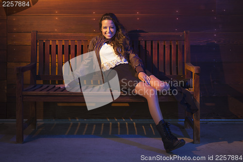 Image of Mixed Race Young Adult Woman Portrait Sitting on Wood Bench
