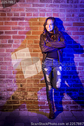 Image of Pretty Mixed Race Young Adult Woman Against a Brick Wall