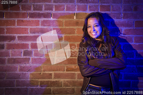 Image of Pretty Mixed Race Young Adult Woman Against a Brick Wall