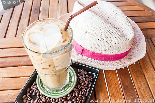 Image of Cold glass of iced milk coffee on wood table