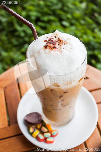 Image of Refreshing iced milk coffee and some sweet
