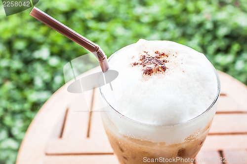 Image of Refreshing glass of iced blended espresso with milk foam