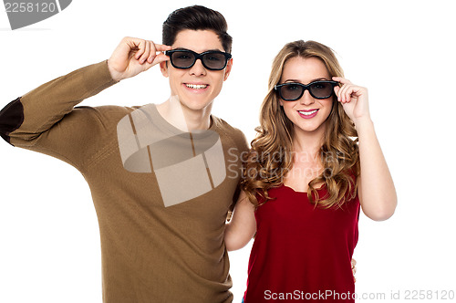Image of Young couple posing to camera with shades on
