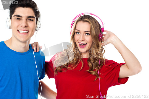 Image of Adorable young couple enjoying music