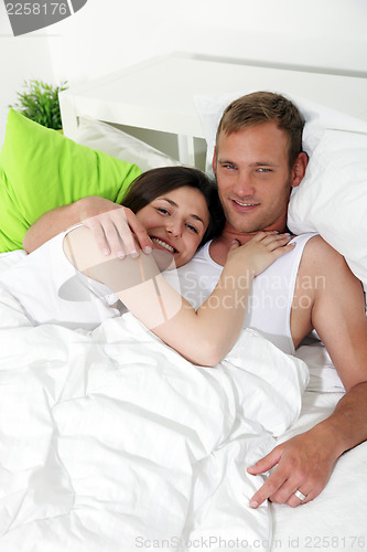 Image of Loving couple resting in bed