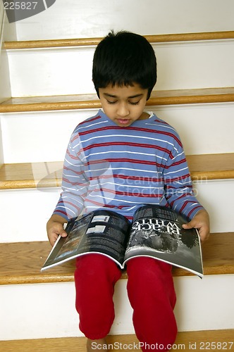 Image of Kid reading a magazine