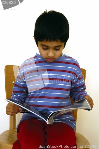 Image of Kid reading a magazine