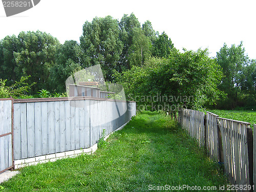 Image of fence and little street in rural manor