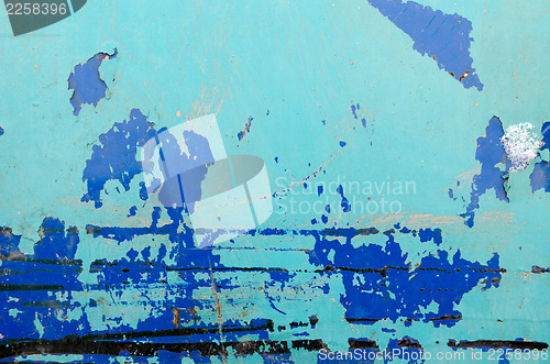 Image of old peeled paint rusty barrel wall blue background 