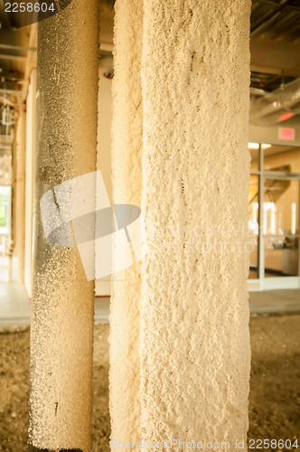 Image of sprayed on fireproofing on a steel building column