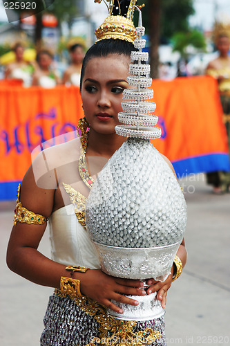 Image of Woman in bright traditional costume during a parade in Phuket, T