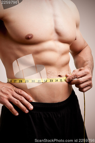 Image of Fit Man Measuring His Waist