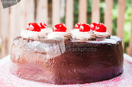 Image of Fresh bake chocolate cake topped with cherry