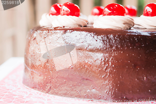 Image of Delicious chocolate cake with cherry on top