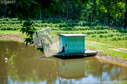 Image of farm building water pump on lake