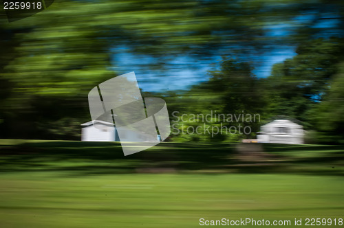 Image of blurred out country landscape while driving