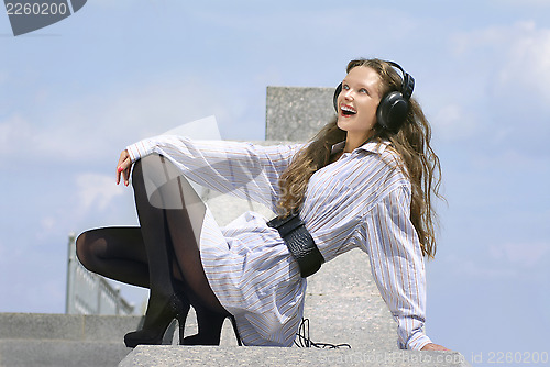 Image of Happy girl is listening music