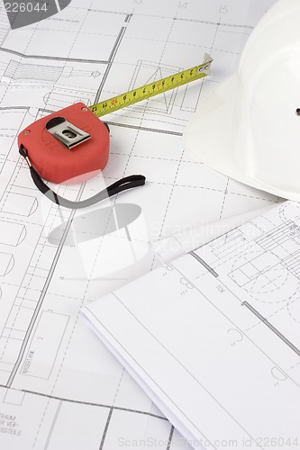 Image of Red measuring tape on construction plans