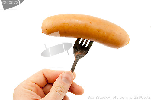 Image of Sausage on a fork isolated on white 