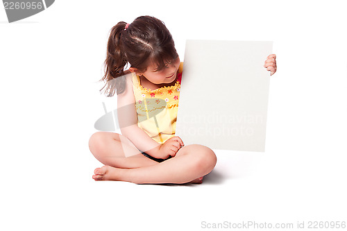 Image of Cute girl sitting with whiteboard