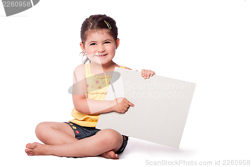 Image of Happy girl sitting pointing at whiteboard