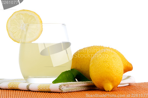 Image of Cup of lemon juice and fresh lemons