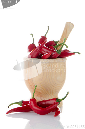 Image of Red chili in wooden mortar 