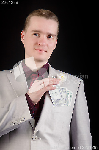 Image of attractive man with banknotes in his pocket