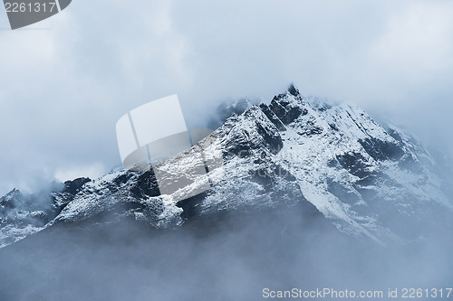 Image of Snowed Mountain peaks hidden in clouds in Himalayas