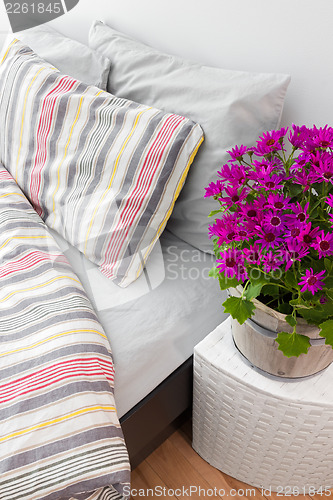 Image of Bright purple flowers decorating a bedroom