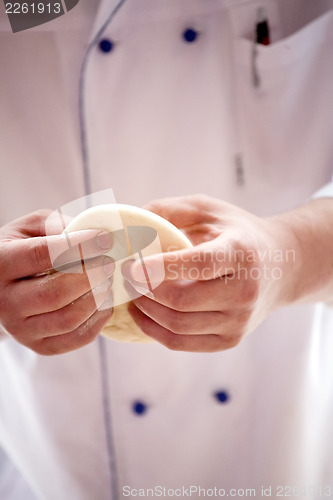 Image of cook's arms making dough